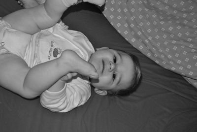 High angle view of boy resting on bed at home