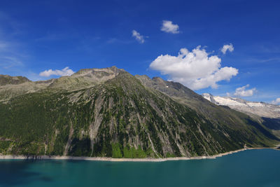 Scenic view of sea and mountains against sky