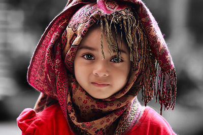 Close-up portrait of cute girl wearing red hat