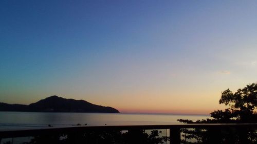 Scenic view of sea against clear sky during sunset