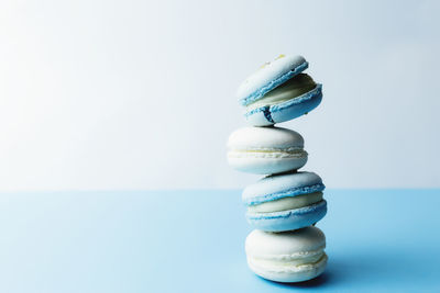 Close-up of stack on blue table against white background