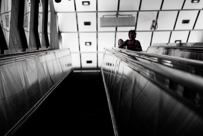 Rear view of man standing on railing