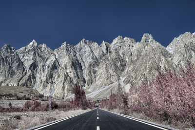 Panoramic view of road amidst mountains against clear sky