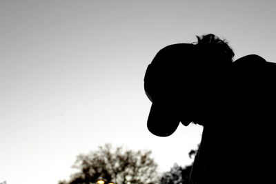 Low angle view of silhouette man against clear sky