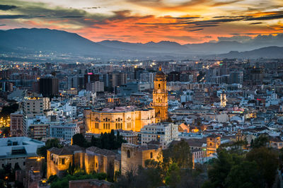 High angle view of illuminated buildings against sky during sunset