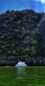 Scenic view of lake in forest against sky