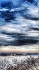 Scenic view of sea against cloudy sky