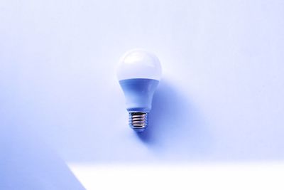 High angle view of light bulb against white background