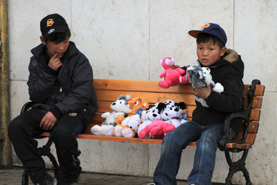 Happy boy sitting with toy toys