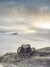 Cowboy hat ready on the rock. leather cowboy accessories