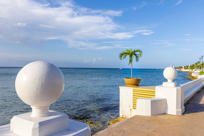 View of swimming pool by sea against sky