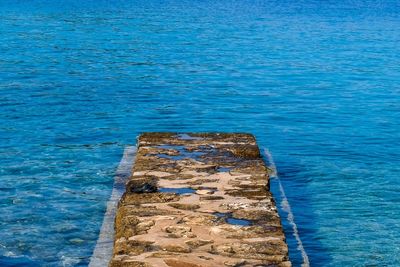 High angle view of rock in sea