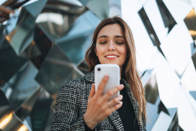 Portrait of young woman using mobile phone