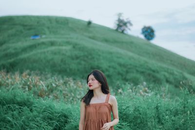 Young woman standing on field