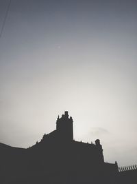 Low angle view of silhouette built structure against clear sky