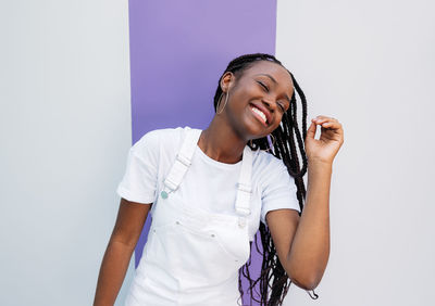 Young man standing against white background