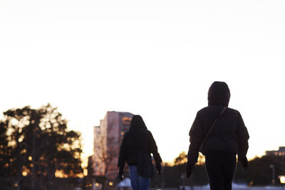 Two people walking in residential district