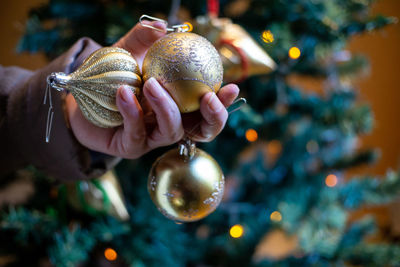 Close-up of hand holding christmas tree