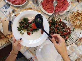 High angle view of person preparing food on table