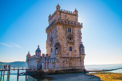 Low angle view of historical building against blue sky