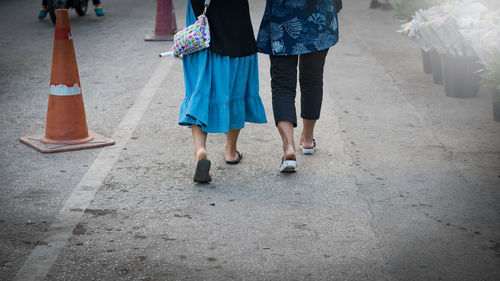 Low section of women walking on street