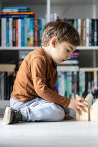 Full length of boy plying at home