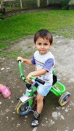 Portrait of boy sitting on grass