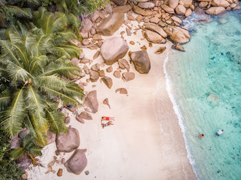 High angle view of couple resting at beach
