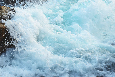 High angle view of waves splashing in sea