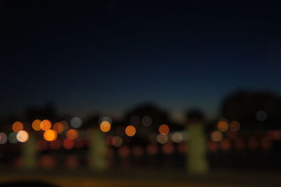 Defocused image of illuminated city at night