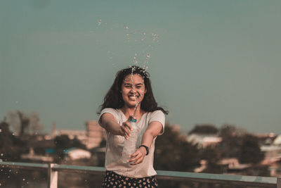 Portrait of a smiling young woman standing outdoors