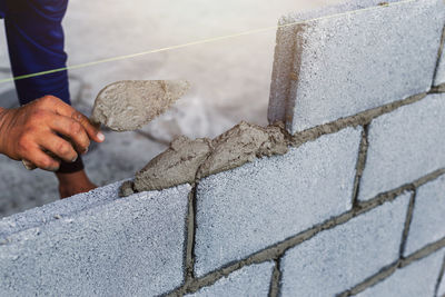 Man working on concrete wall