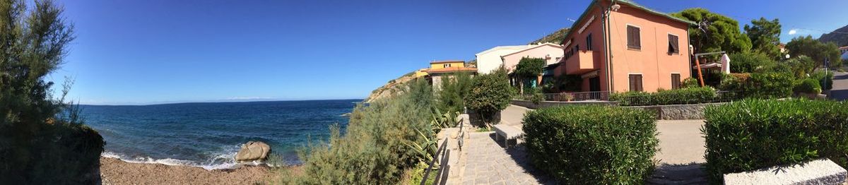 Panoramic view of sea and buildings against clear sky