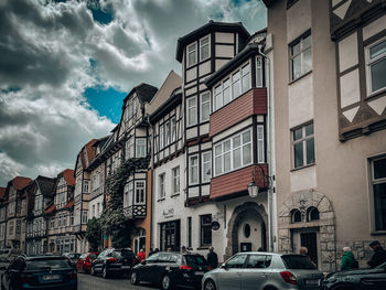 Cars on street against sky