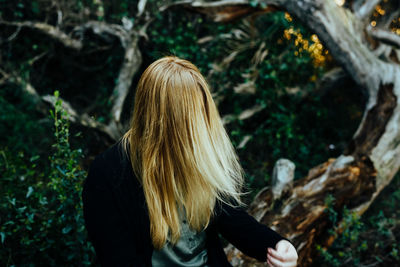 Woman with blond hair in forest