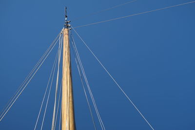 Low angle view of mast against clear blue sky