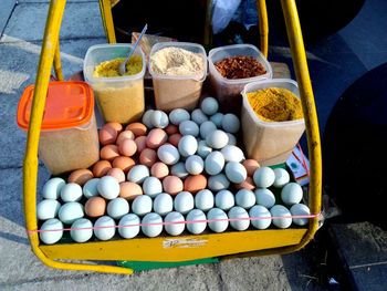 High angle view of eggs and ingredients for sale at market stall