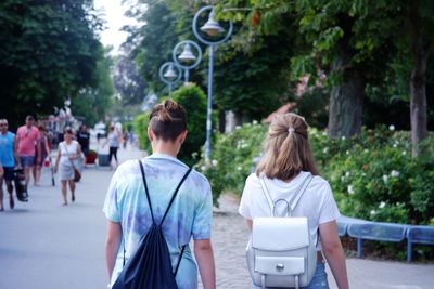 Rear view of people on street in city