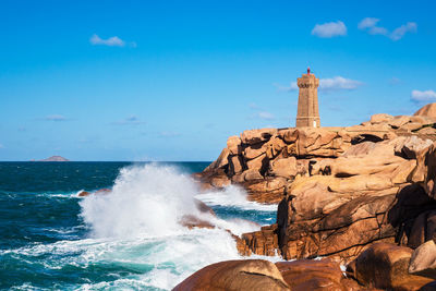 Scenic view of rocks on beach against sky
