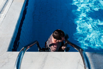 High angle view of man swimming in pool