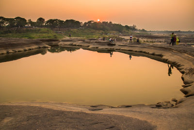 Scenic view of lake against sky during sunset