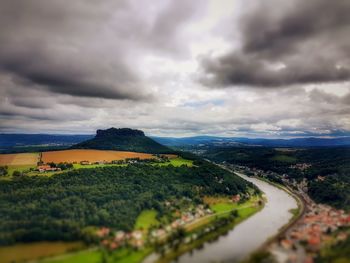 Scenic view of field against storm clouds