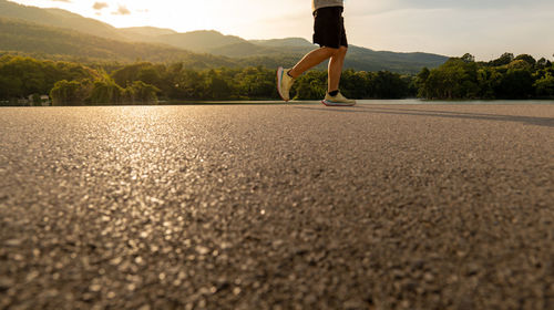 Rear view of woman walking on road