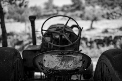 Close-up of abandoned truck on field