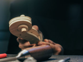 Luthier working a classic violin scroll