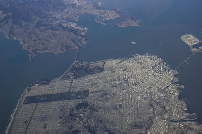 High angle view of lake by buildings in city