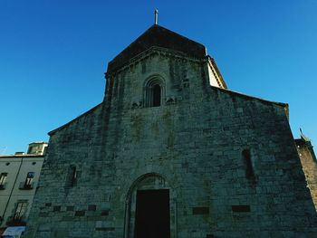 Low angle view of bell tower against blue sky