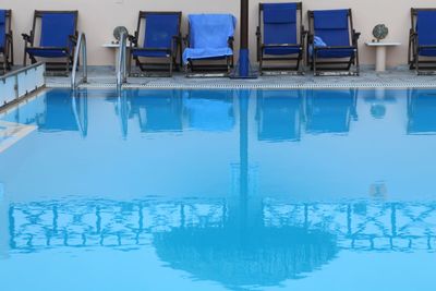 Reflection of swimming pool in lake during winter