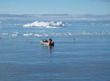 People on beach against sky