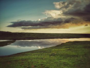 Scenic view of sea against cloudy sky